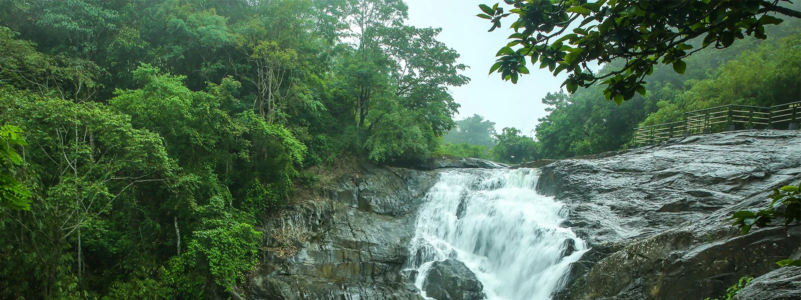 Kanthanpara Waterfalls flowing through rocky terrain in Wayanad forest